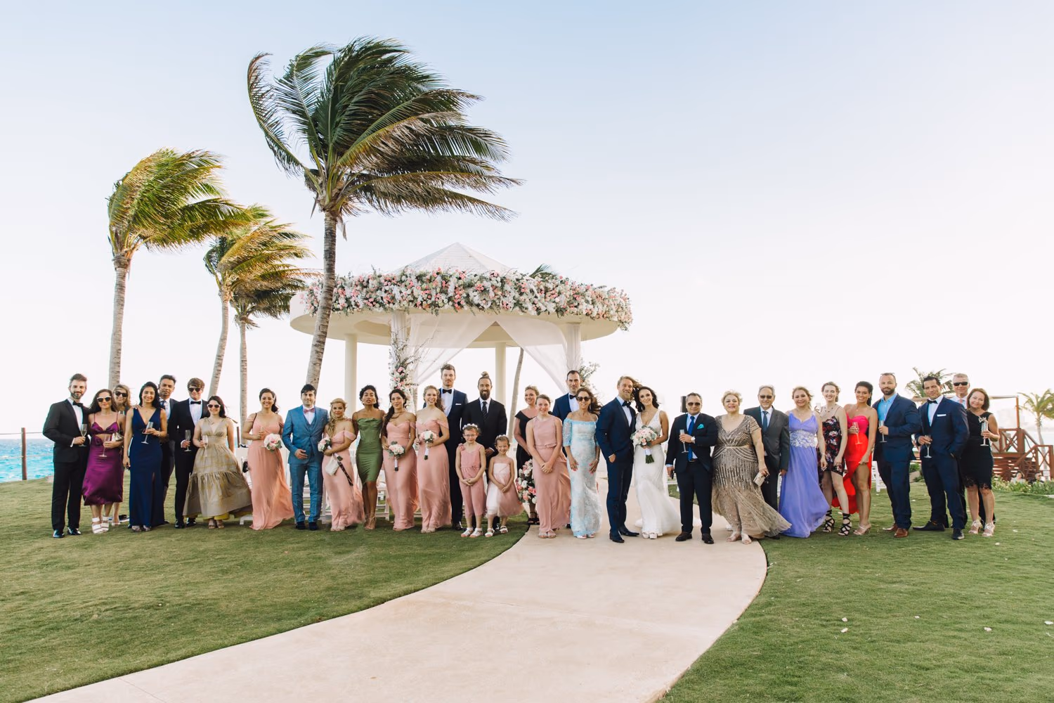 The whole wedding party on the lawn after the ceremony at Hyatt Ziva Cancun