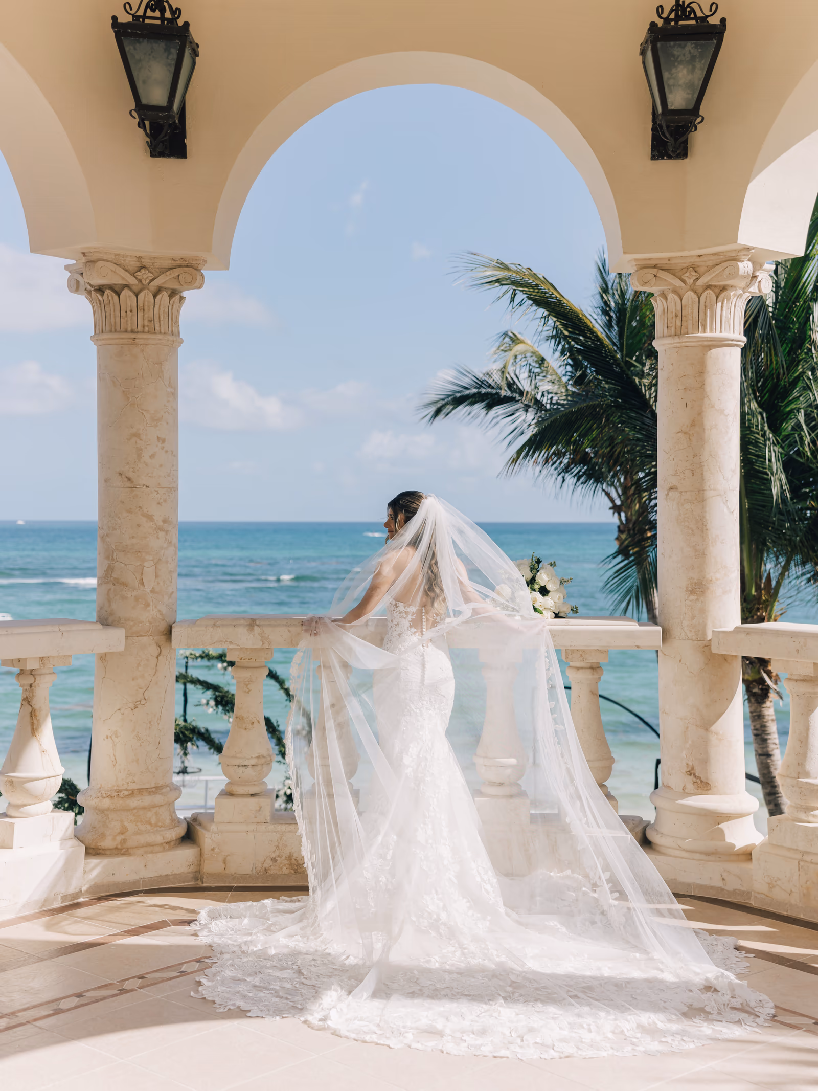 A bride on an arched terrace above the Caribbean
