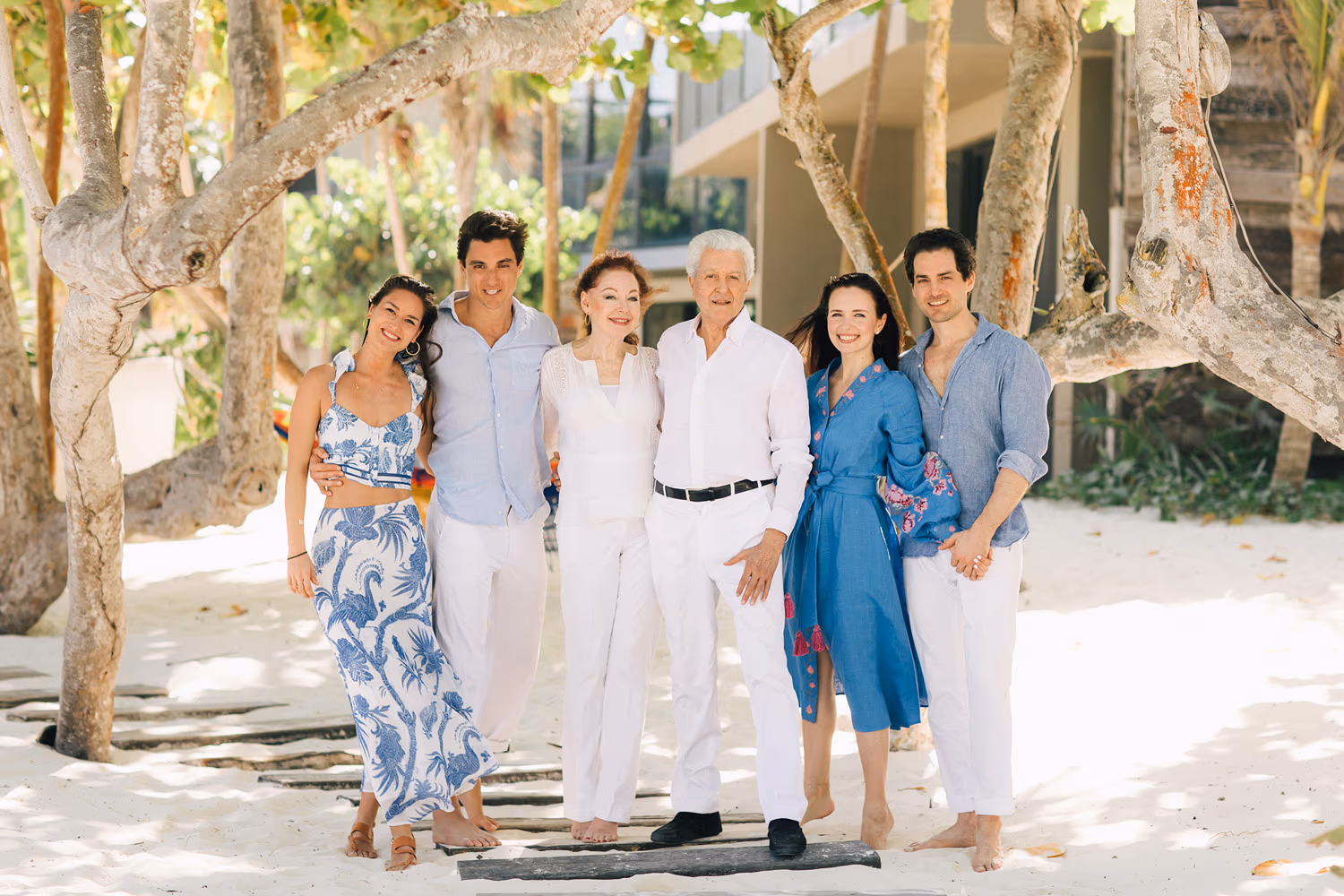 Family session in Tulum at Casa Malca with parents walking hand in hand with their child.