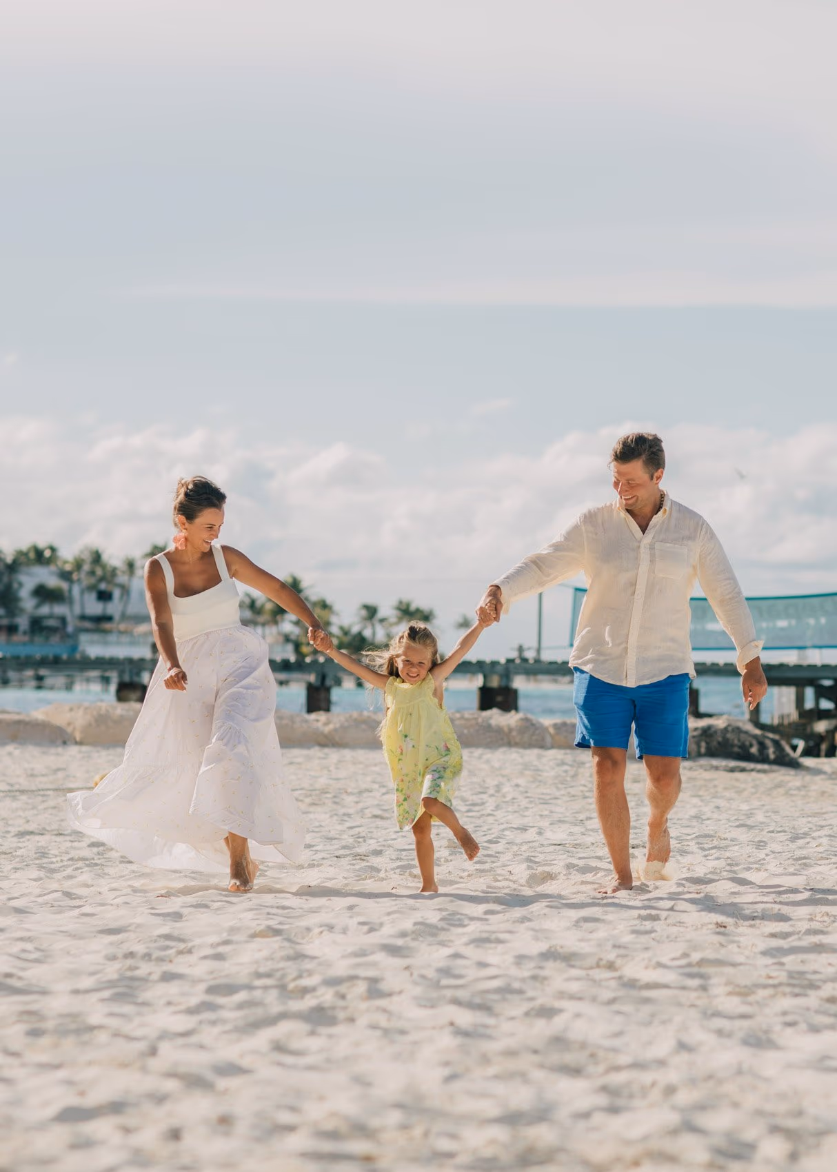 Family photoshoot in Cancun with children playing on the beach.