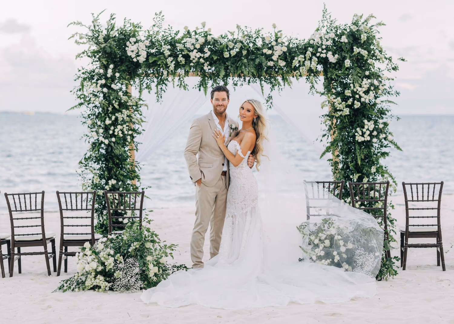 Beach wedding in cancun at hotel garza blanca, couple in wedding arch.